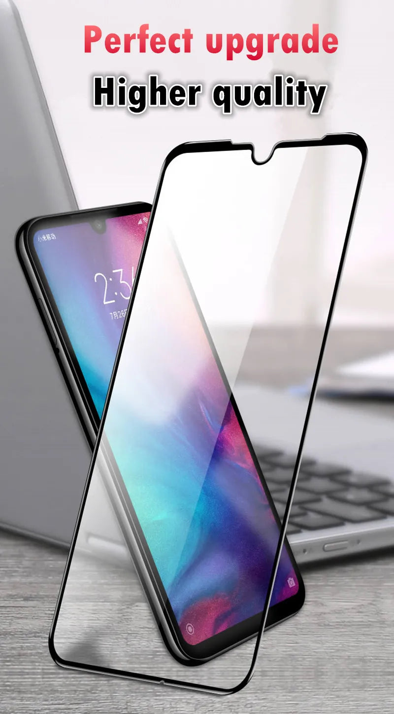 A smartphone with a vibrant display sits next to the LITBOY Tempered Glass Protector for Xiaomi Devices on a wooden surface, while a partially visible laptop in the background adds context. The text reads Perfect upgrade, Higher quality, highlighting its compatibility with Xiaomi devices.