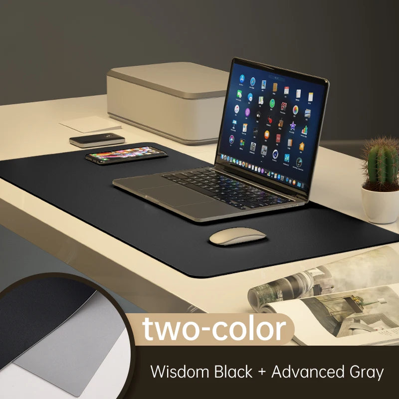 A chic desk setup highlights the Xummen Large Mouse Pad in Wisdom Black + Advanced Gray. This Waterproof PU Gaming Desk Mat offers a non-slip base for stability with your laptop, wireless mouse, smartphone, a small cactus, and a closed storage box.