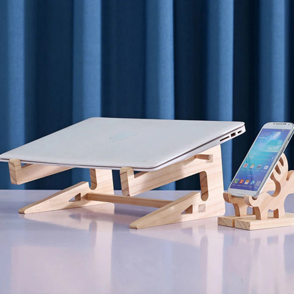 A white laptop and smartphone rest on a Universal Wooden Laptop Holder - Detachable Stand, elevating them for better viewing. Framed by a blue curtain, this elegant desk setup also includes free shipping with your purchase.