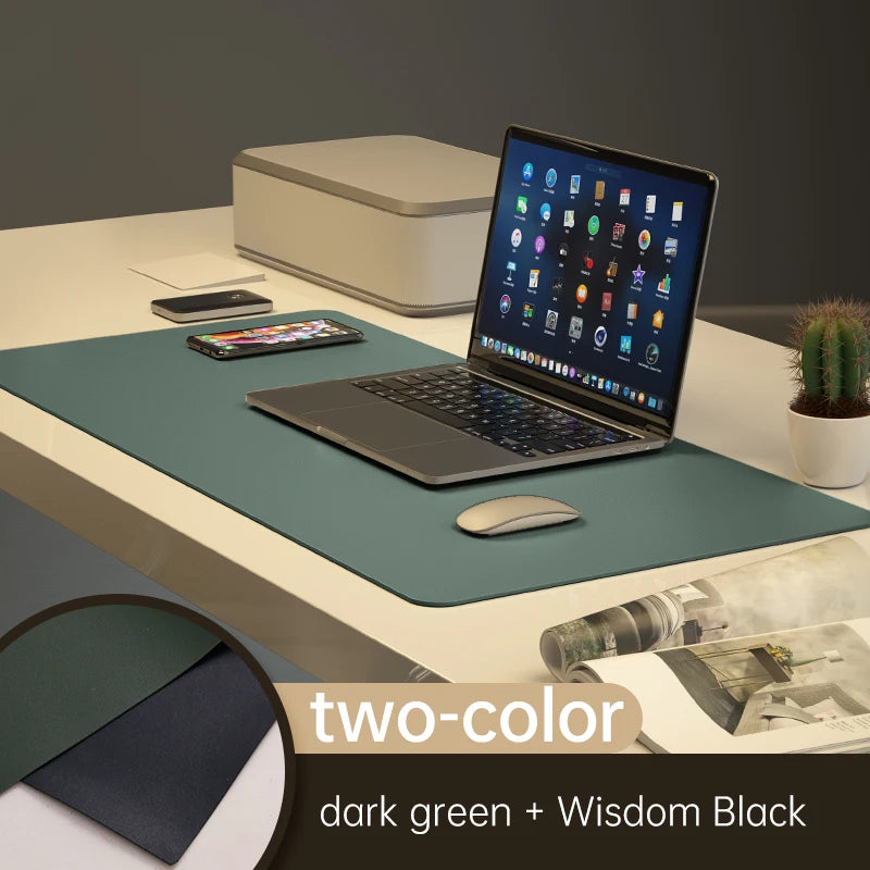 An office setup features a laptop with apps, smartphone, mouse, and a small cactus on the Xummen Large Mouse Pad - Waterproof PU Gaming Desk Mat in dark green and Wisdom Black. Its non-slip for stability. Nearby are a printer and magazine.