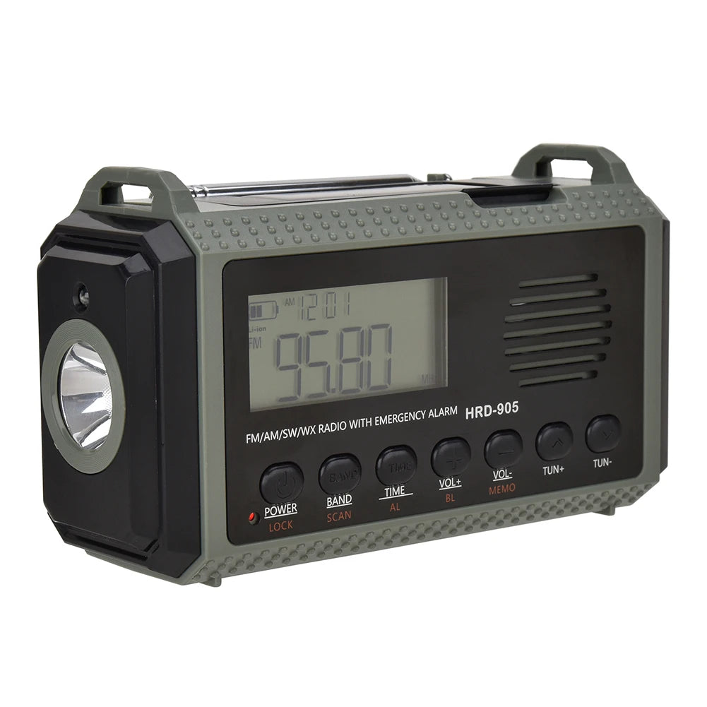 The APWIKOGER 10,000mAh Solar Hand Crank Emergency Radio includes a 95.8 digital display, left-side flashlight, several control buttons below, multi-band capabilities, and a convenient top handle for easy transport.