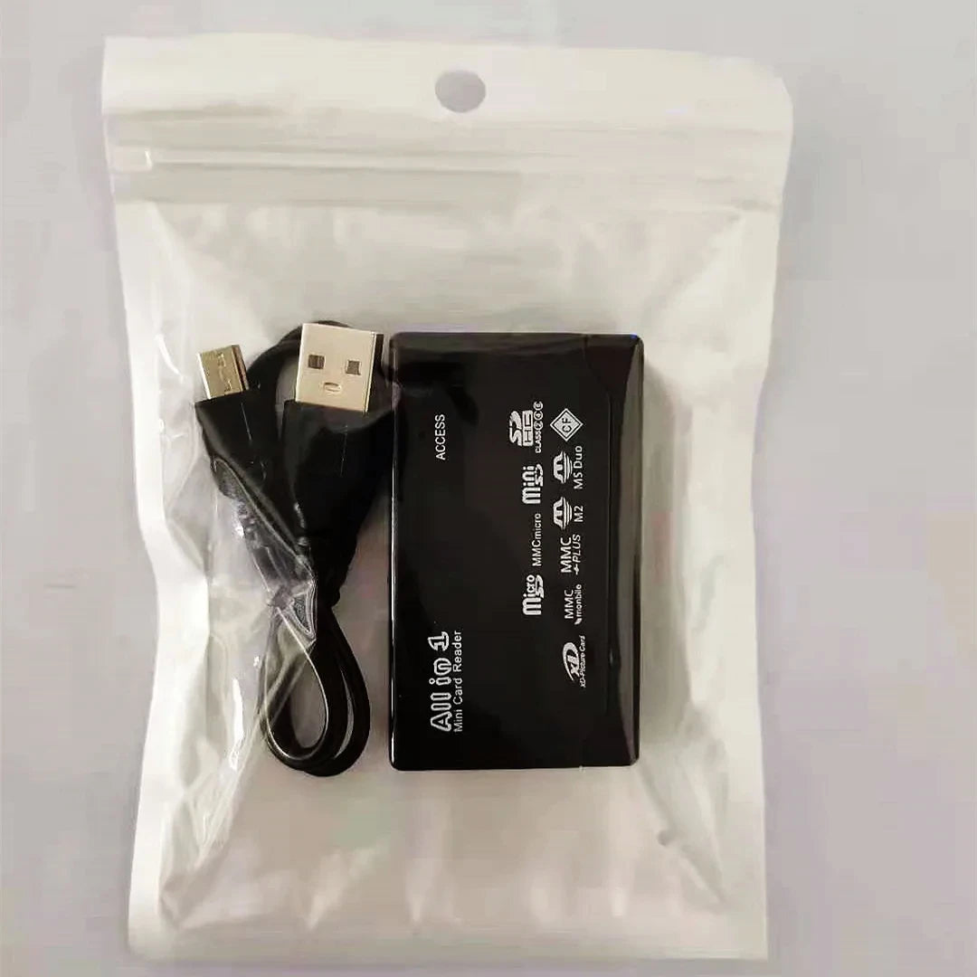 The USB 2.0 Mini Memory Card Reader With Multi-Card Support is a black reader with multiple slots and white printed card type labels, includes a USB cable, and comes in a clear, resealable plastic bag.