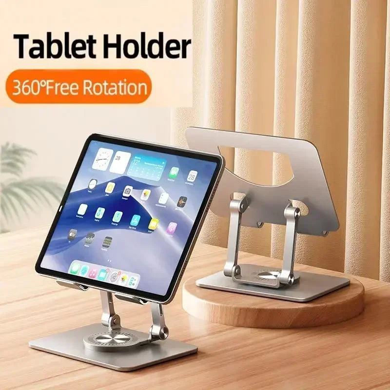 An aluminum stand featuring a 360-degree rotation holds a tablet on a wooden surface, with another stand in the background. Text reads: Adjustable 360° Rotatable Tablet Stand for 4.7-12 Devices.