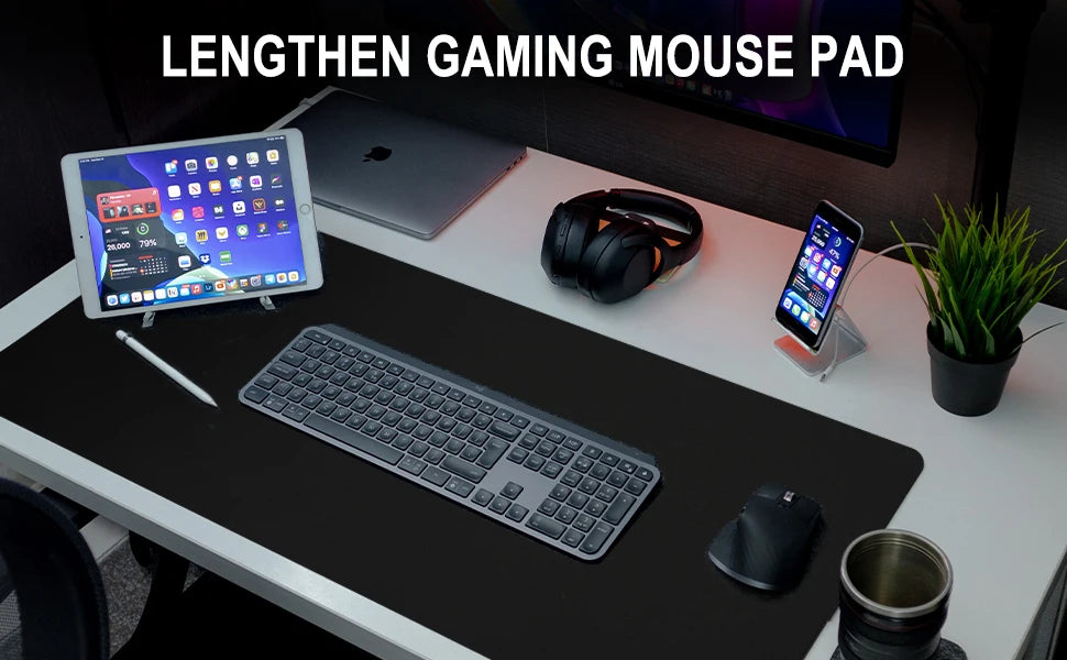 A sleek workspace features the Ziyoulang Large Mouse Pad 800x300mm with Stitched Edges, perfectly complementing a wireless keyboard and mouse, tablet, smartphone on a stand, headphones, laptop, stylus, potted plant, and metallic cup in a modern organized setup.