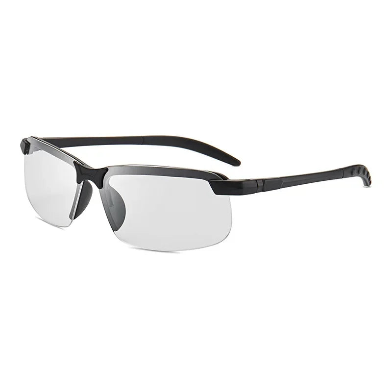 The HARKO Polarized Night Vision Cycling Sunglasses feature sleek, semi-rimless black frames and clear lenses perfect for outdoor adventures. With straight, slender arms that curve slightly, they rest against a plain white background.