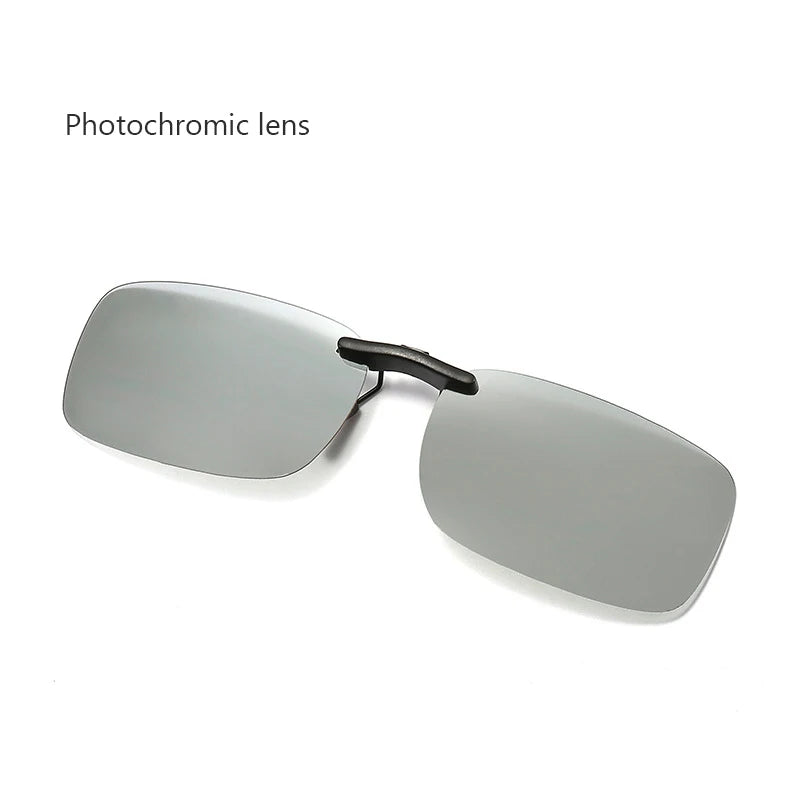 A pair of rectangular, rimless Honey Joe Polarized Clip-On Sunglasses with a dark bridge lies on a white surface. Honey Joe appears in the top left corner, underscoring their advanced UV400 protection for superior eye safety.