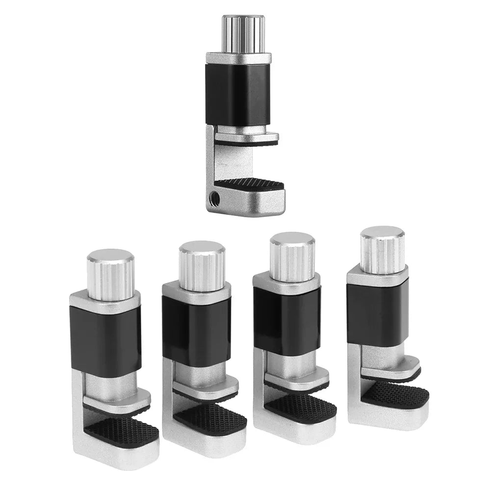 Five adjustable leveling feet with black rubber pads and silver parts are set against a white background. One stands upright, resembling a MOJOYCE Adjustable Alloy Clamp for Secure Mobile Repairs, while the others lie horizontally.
