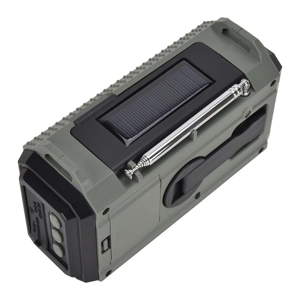 A green portable speaker with a solar panel on top and a black handle, similar to the APWIKOGER 10,000mAh Solar Hand Crank Emergency Radio. Its rugged, textured edges and rectangular shape make it ideal for outdoor adventures.