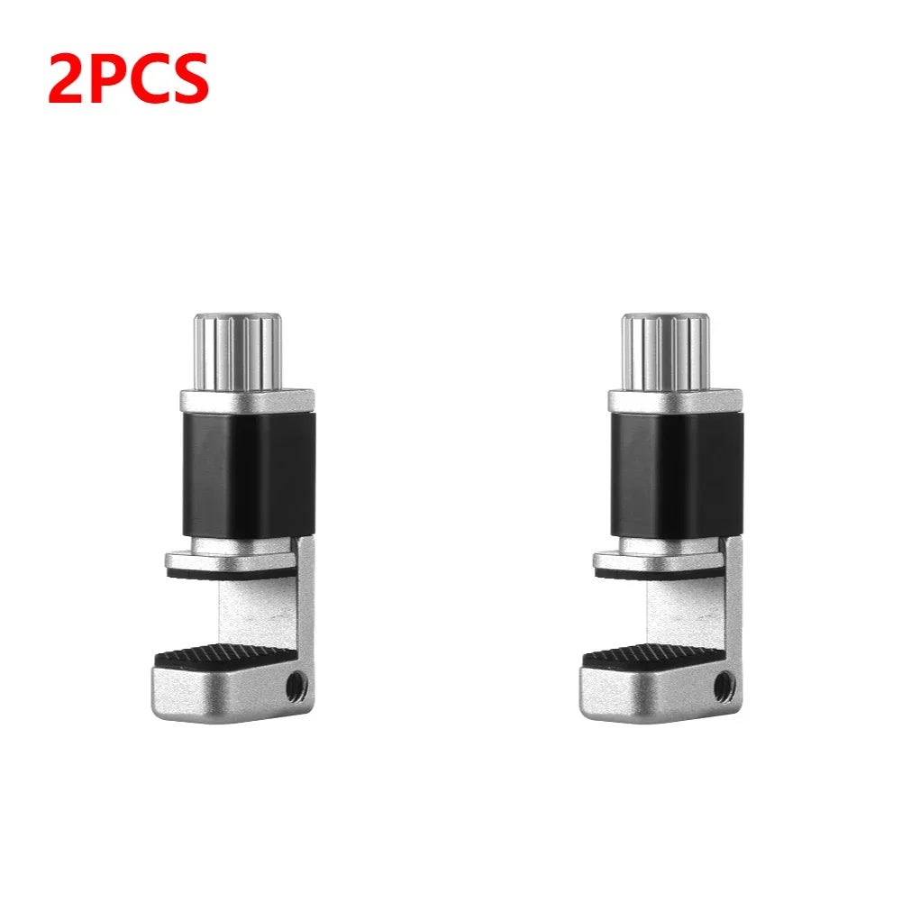 Two silver-and-black MOJOYCE Adjustable Alloy Clamps with ridged grips and cylindrical tops are showcased on a white background, with 2PCS in red at the top left corner. Ideal for secure mobile repairs, they ensure precision and stability.