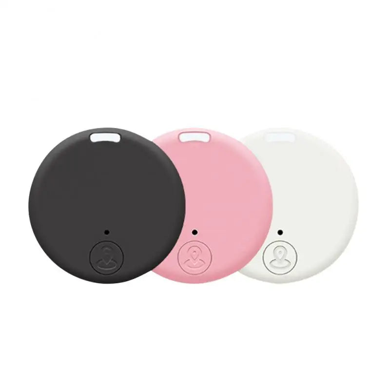 Three round NoEnName Bluetooth GPS Tracker devices in black, pink, and white are showcased side by side. Each Smart Key Finder device features a small button with a symbol at the bottom, ideal for keeping your essentials safe and within reach.