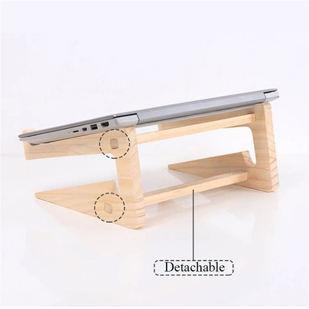 The Universal Wooden Laptop Holder - Detachable Stand is depicted with a silver laptop on it, showcasing dotted circles at its connection points. Its minimalist design stands out against a plain white background. Enjoy free shipping with this elegant stand purchase.