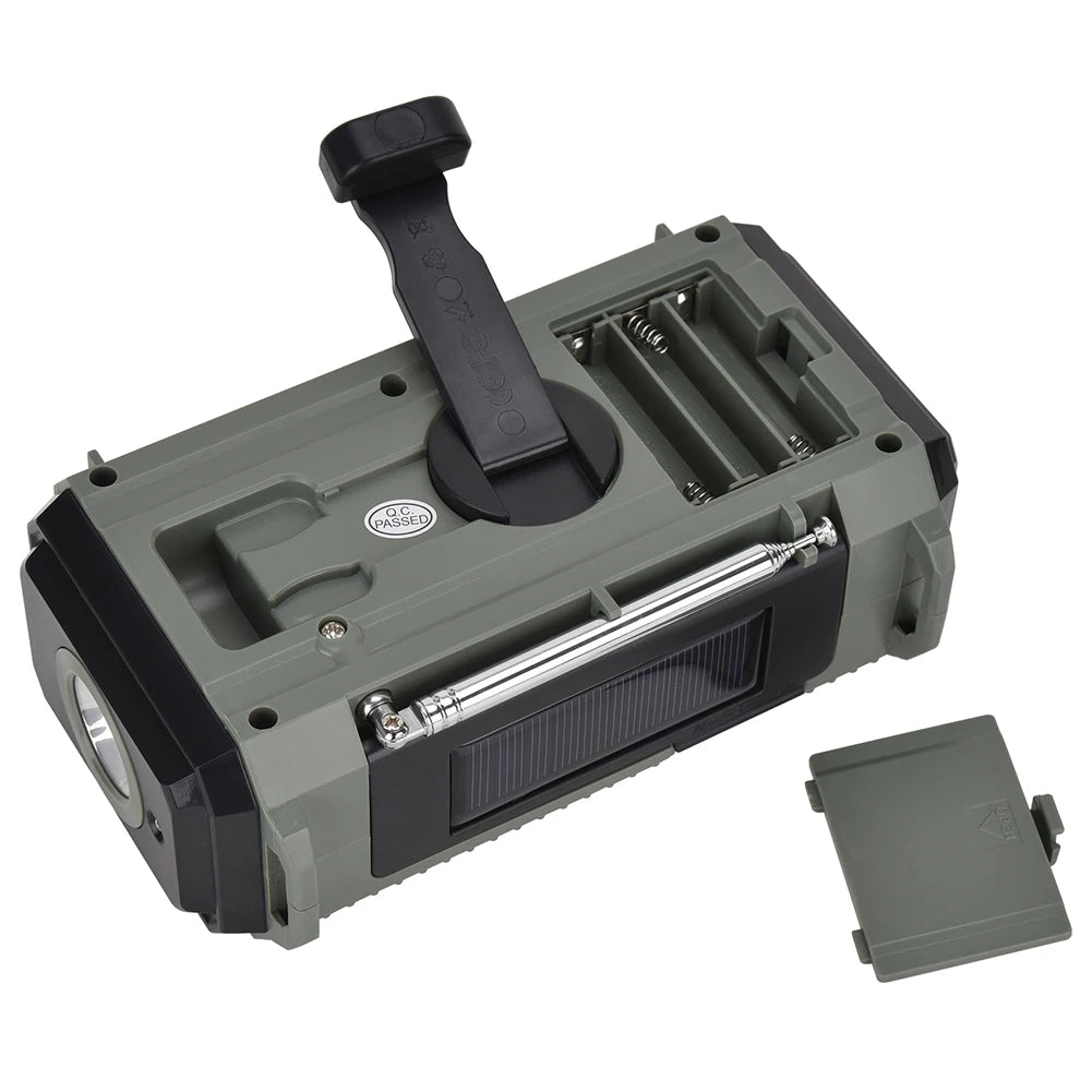 The APWIKOGER 10,000mAh Solar Hand Crank Emergency Radio is portable and green, with a light and accessible open battery compartment. Its compact design features multi-band capabilities, and the detached battery cover is beside it for easy use.