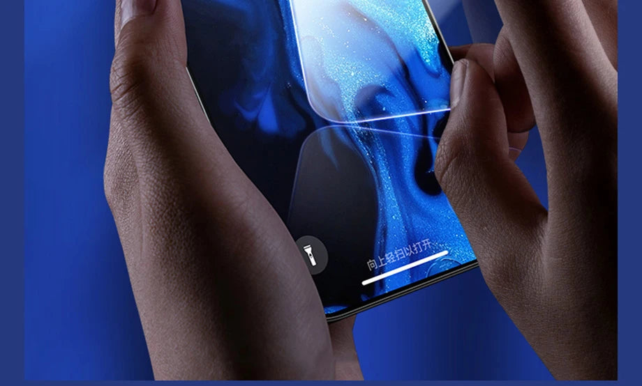 A close-up of hands holding a smartphone with a blue abstract wallpaper and Chinese text, featuring the YKSPACE 2Pcs Anti Blue-Ray Tempered Glass Screen Protector for advanced eye care.