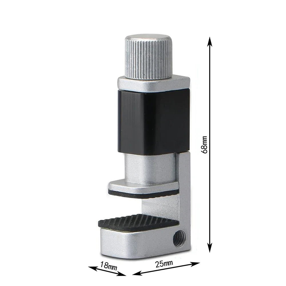 The MOJOYCE Adjustable Alloy Clamp for Secure Mobile Repairs is a strong metal tabletop vise with a silver adjustable screw, black cylindrical section, and rubber-padded clamp. Measuring 68mm tall, 25mm wide, and 18mm across the clamping area, its perfect for secure mobile repairs.