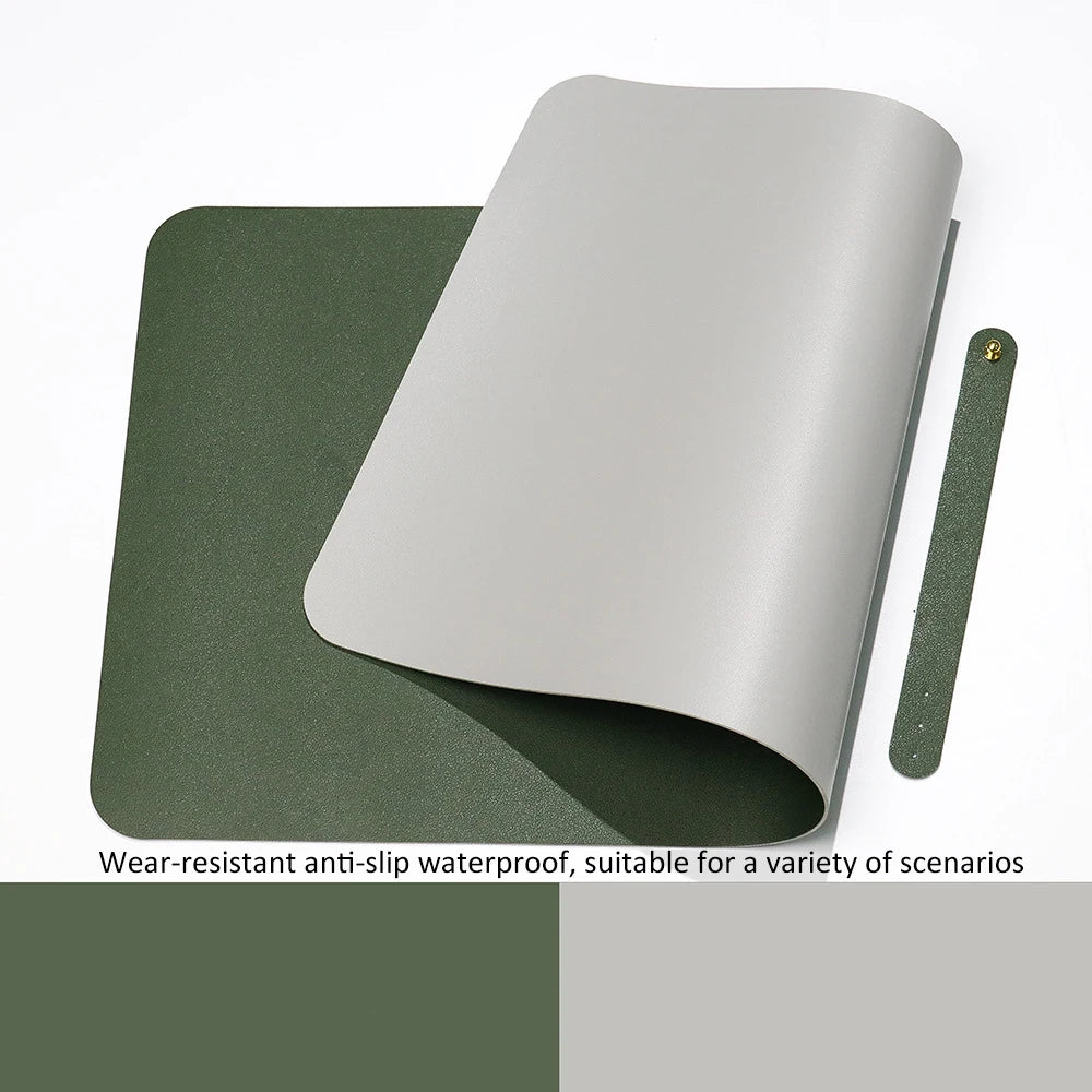 The Xummen Large Mouse Pad, a versatile gray and green Waterproof PU Gaming Desk Mat, is partially rolled to display its colors. It includes a matching strap with a metal button. Text below states: Wear-resistant, non-slip base; ideal for various gaming scenarios.