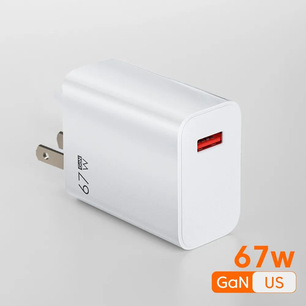 A 67W GaN USB Charger With Quick Charge 3.0 Technology is shown on a plain gray background, featuring a compact design with a foldable US plug and USB port. 67W GaN US in orange text highlights efficient charging in the corner.