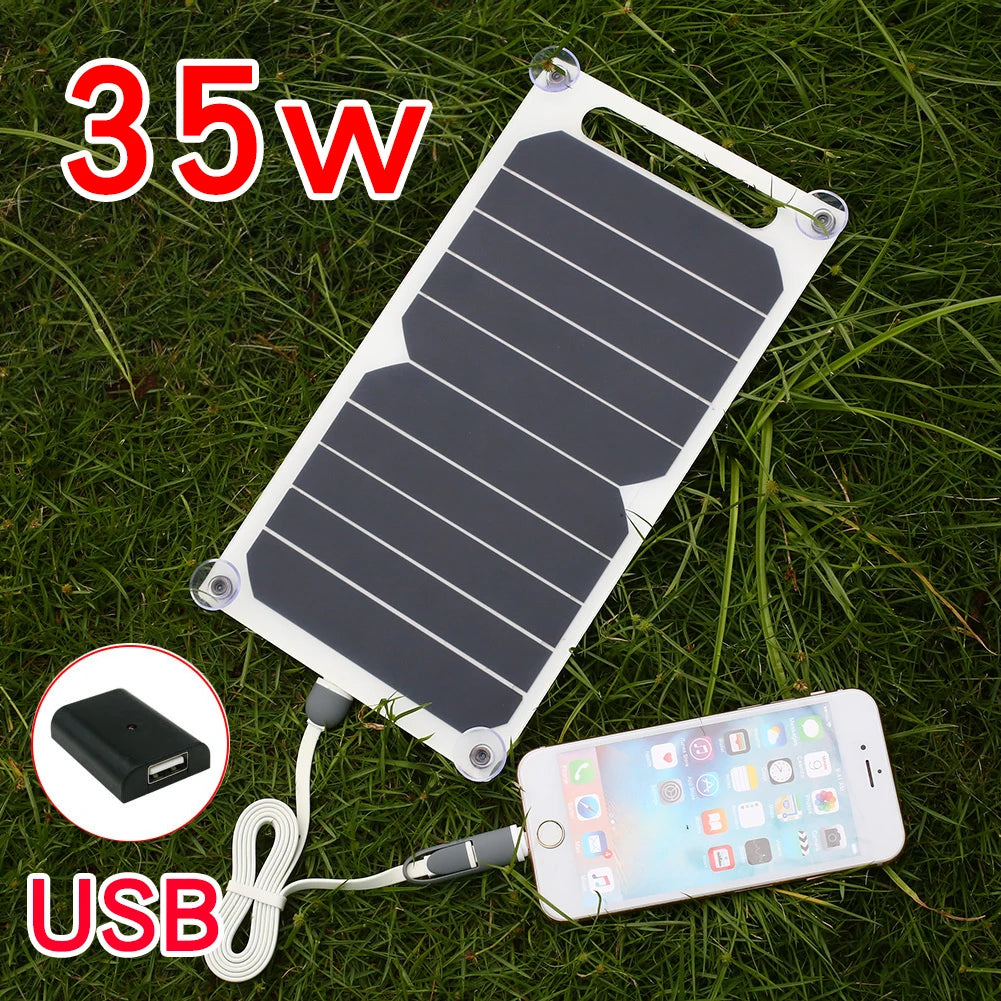 The EESBAO 35W Solar Panel - Portable USB Charger, resting on the grass, is perfect for camping. Connected to a smartphone via cable, it features a built-in USB adapter, making it ideal for outdoor adventures.