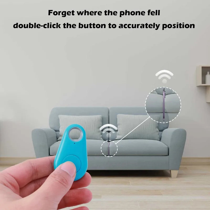 A hand with a Mini Smart Bluetooth Tracker - GPS Locator for Pets in front of a gray sofa shows its ability to find your phone. Real-time tracking signals aid in effortlessly retrieving the phone from the sofa.