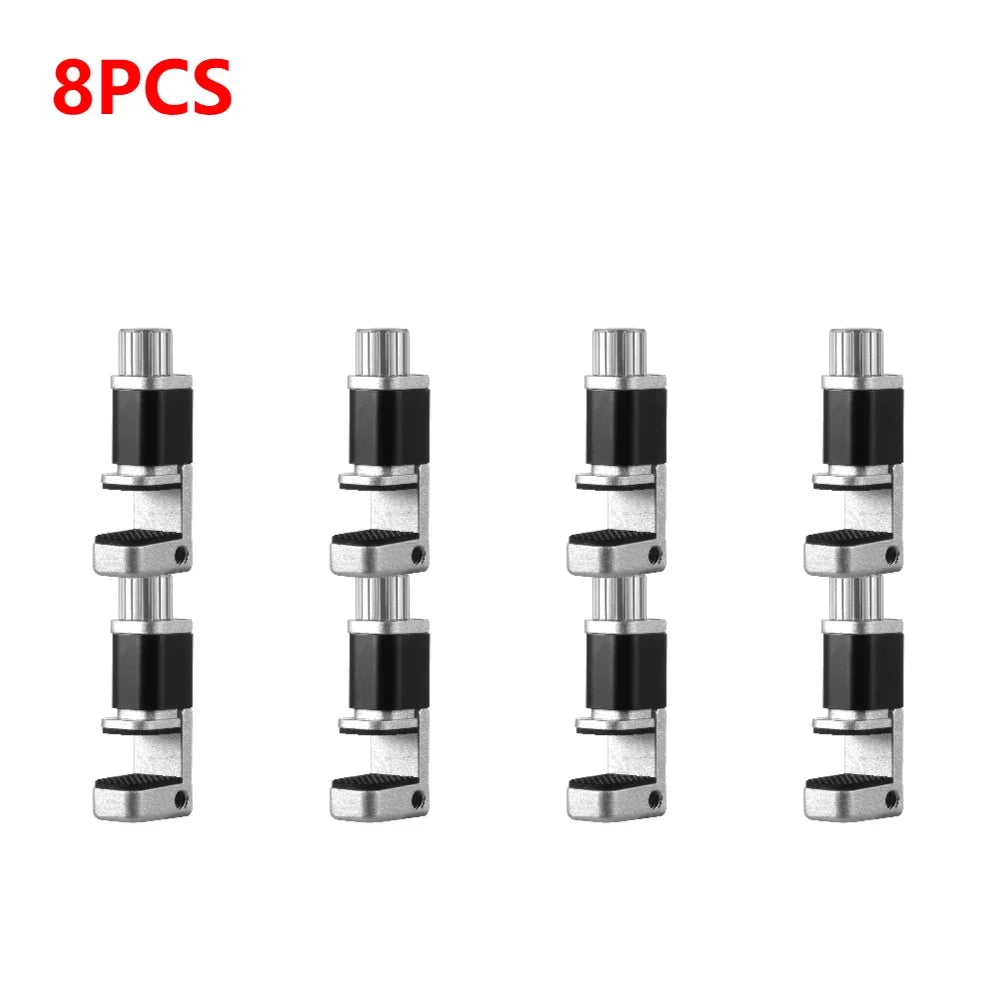 Eight identical cylindrical camshaft adjusters are aligned in two rows, featuring black rubber segments, silver metal ends, and mechanical details. MOJOYCE Adjustable Alloy Clamp for Secure Mobile Repairs is written in red at the top left on a plain white background.