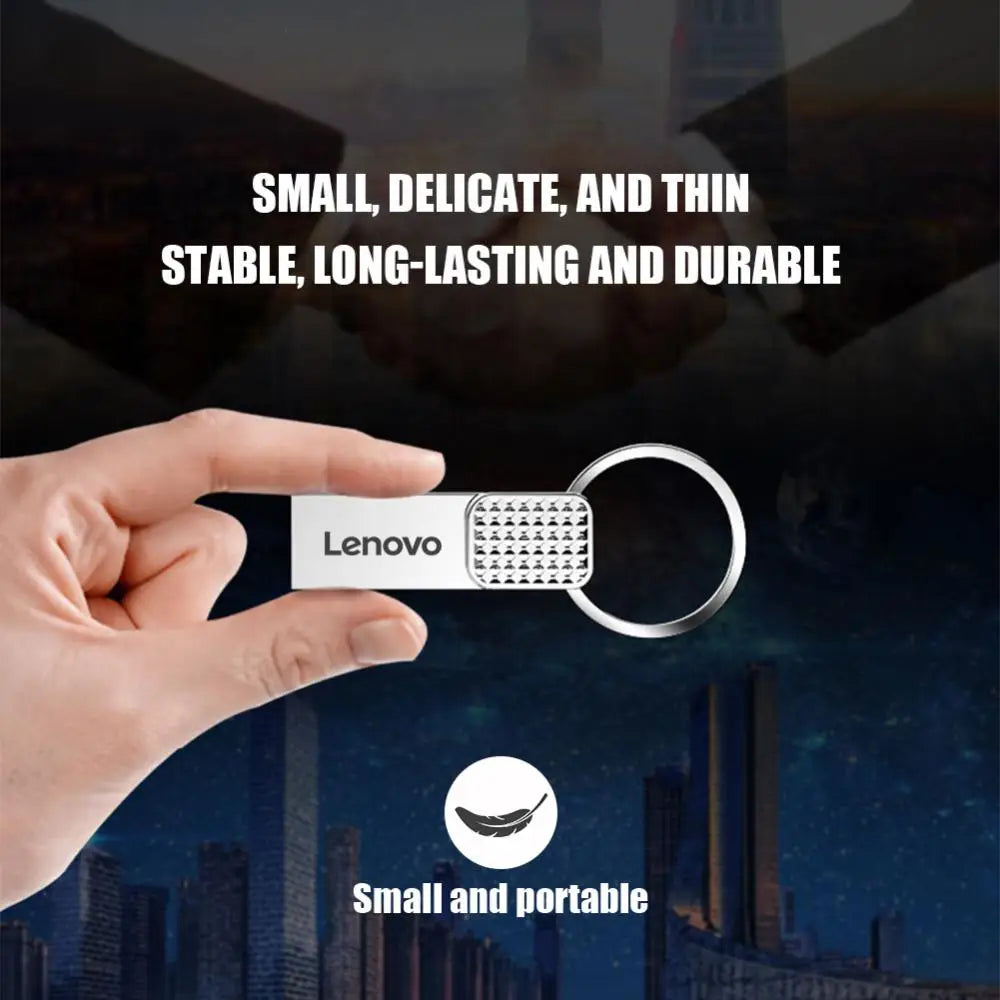 A hand holds a Lenovo 2TB USB 3.0 OTG Pen Drive keyring. Text above: Small, delicate, thin. High-speed, long-lasting durable. Below: A feather with Small and portable on a nighttime cityscape background.