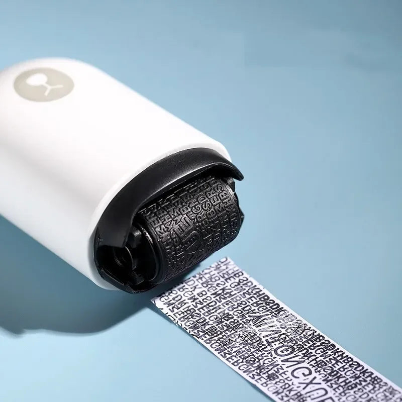 A close-up of the NoEnName Roller Stamp - Quick Drying Privacy Seal marking black, scrambled text on a white surface to obscure details and protect sensitive data. The light blue background highlights its efficient, quick-drying coverage for privacy.