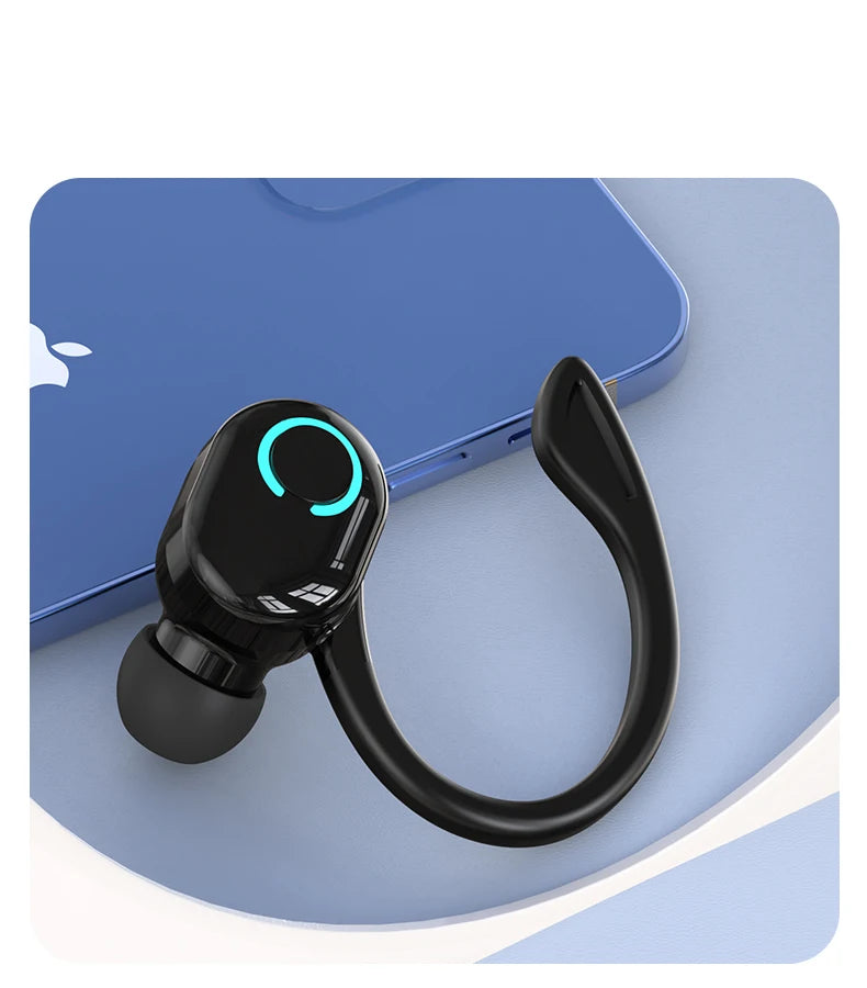 The VAORLO Bluetooth 5.2 Mini Headphone, a black wireless earbud with an ear hook and circular LED light, elegantly rests on a blue laptop atop a blue and white surface. It is ready to deliver noise-cancelling sound quality with its advanced features.