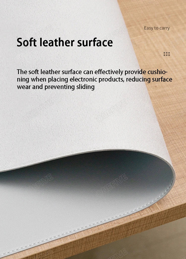 The AIPHY Large PU Leather Mouse Pad elegantly covers a wooden desk, featuring soft cushioning to prevent wear and sliding of electronics. This chic, waterproof mat provides both protection and sophistication for your workspace.