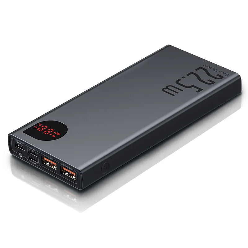 The Baseus 10000mAh Power Bank is displayed on a white background, featuring a sleek black design with fast charging, two USB ports, a USB-C port, and a digital display showing 4V 12V 22W in red. Its powerful 22W capacity is prominently printed on the surface.