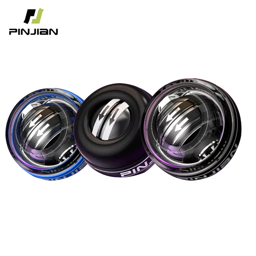 Three reflective metallic Gyro Balls in blue, black, and purple hues, each branded with the PINJIAN logo. These spherical Wrist Trainer Self-starting Gyro Balls offer adjustable intensity. The background is plain white.