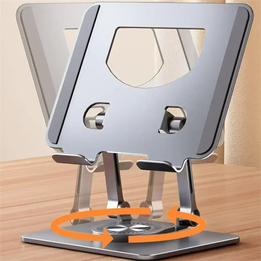 The Adjustable 360° Rotatable Tablet Stand for 4.7-12 Devices, made of aluminum, sits on a wooden surface with hinged joints and ventilation cutouts. It features orange arrow indications for its rotating base and doubles as a versatile laptop holder.