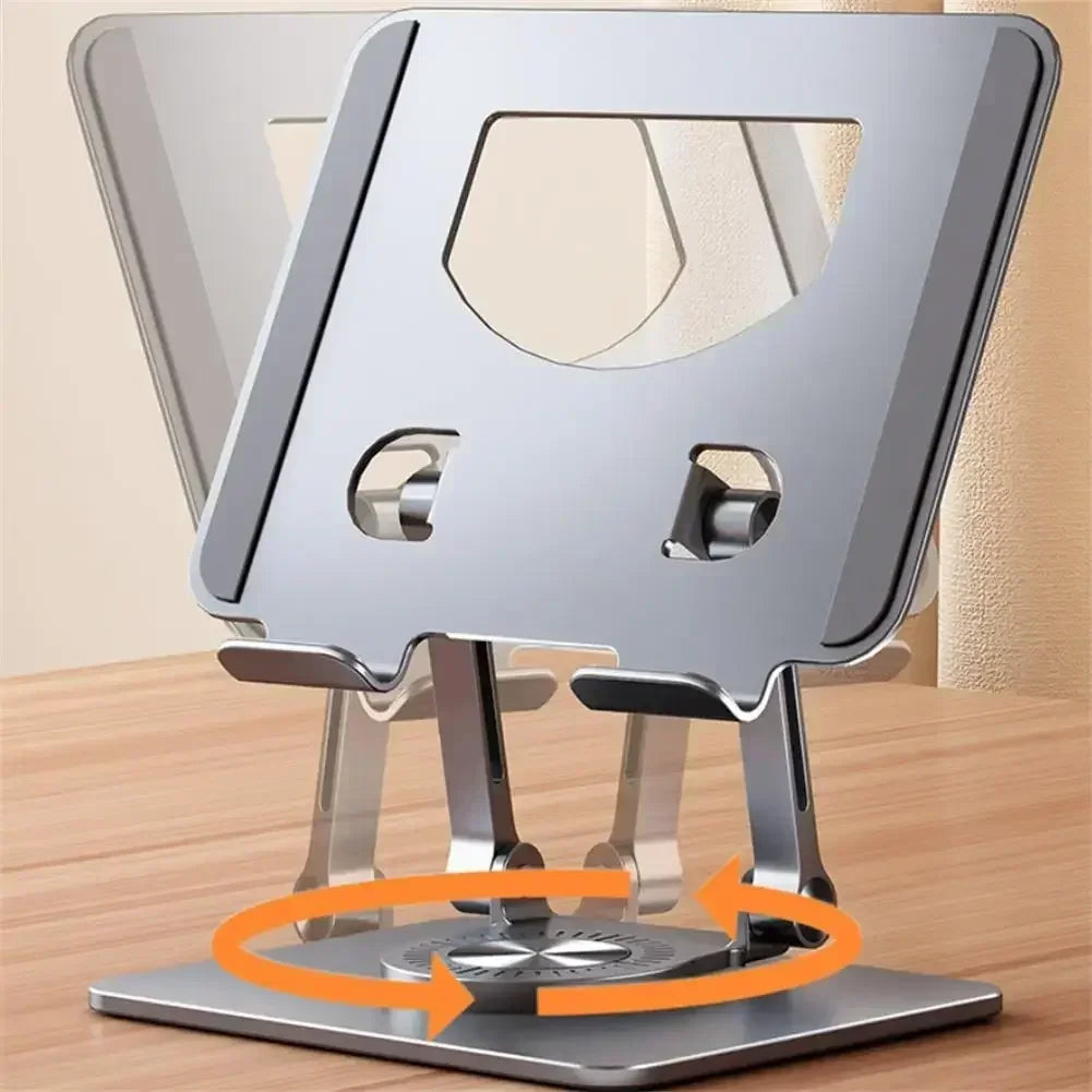 The Adjustable 360° Rotatable Tablet Stand for 4.7-12 Devices sits on a wooden surface, showcasing a sleek aluminum design with ventilation cut-outs and rotational arrows on the base, allowing ergonomic positioning.