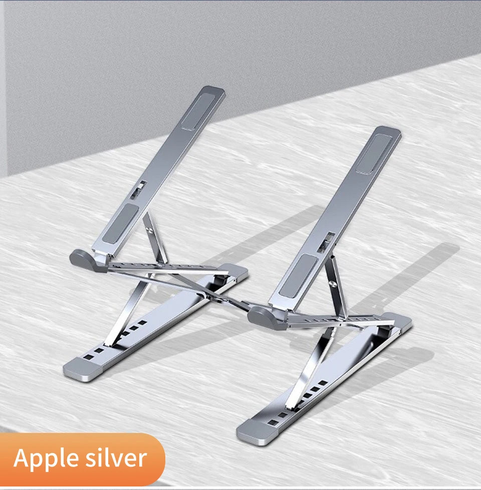 An elegant Adjustable Aluminum Laptop Stand for Comfort and Portability rests on a light surface. The minimalist Apple silver design, featuring an orange label at the bottom left corner, offers ergonomic ease with adjustable arms.