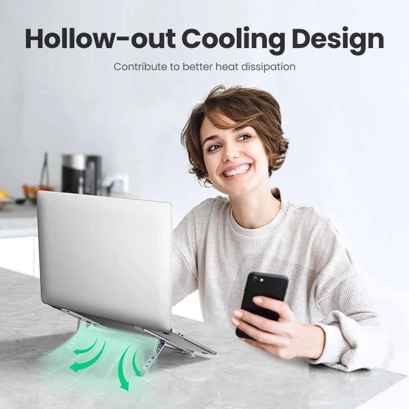 A person smiles holding a smartphone with a UGREEN Adjustable Foldable Aluminum Laptop Stand in front of them. Green arrows show airflow for cooling, accompanied by text: Hollow-out Cooling Design - Contribute to better heat dissipation.