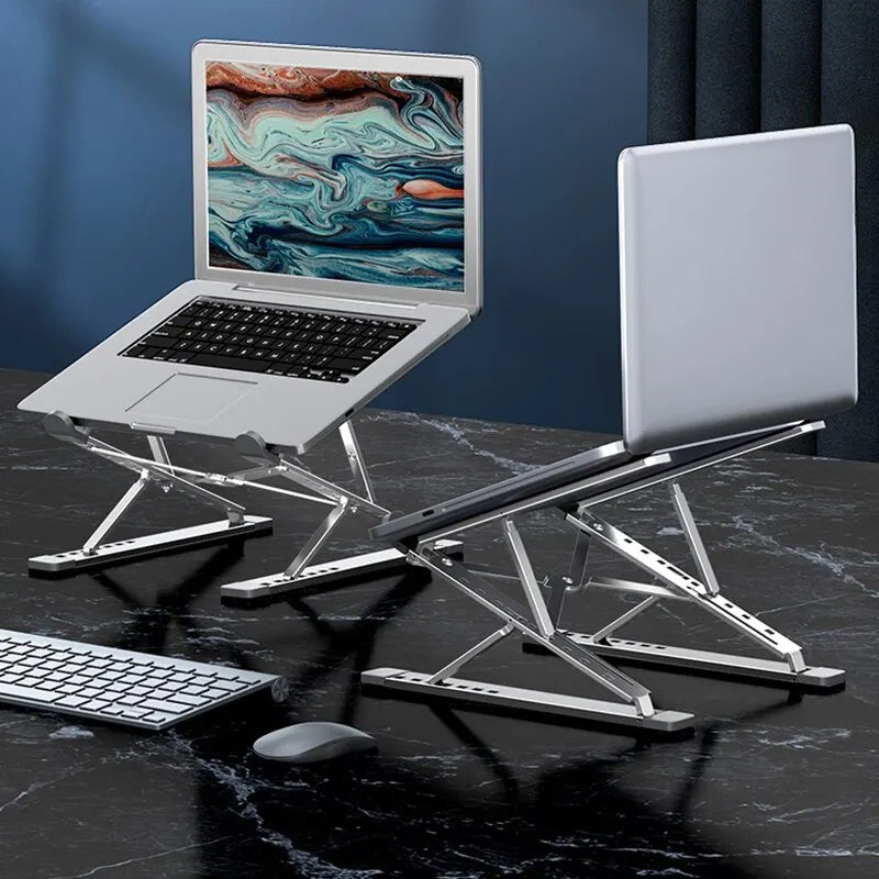 Two laptops sit on marble-textured desks, each on an Adjustable Aluminum Laptop Stand for Comfort and Portability. The left screen displays a colorful abstract design, while a wireless keyboard and mouse set are arranged ergonomically in front.