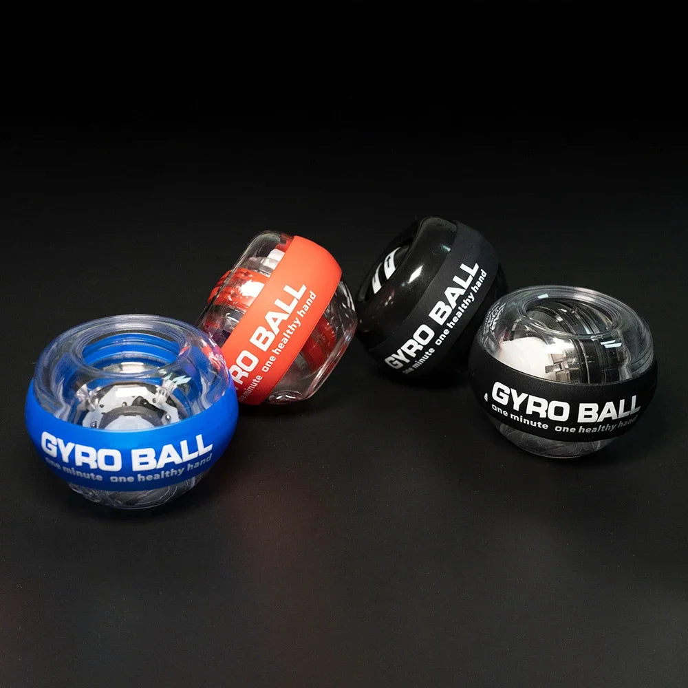 Four LED Gyro Wrist Force Handballs rest on a black surface in blue, red, black, and transparent with GYRO BALL text. These spherical designs showcase internal mechanisms ideal for strength training and have optional LED versions for added flair.