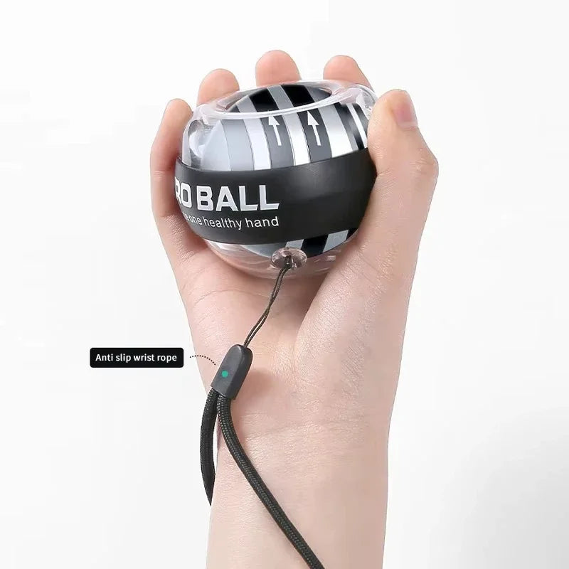 The Gyroscope Power Ball Forearm Strength Trainer is a transparent device with black stripes and text, featuring an anti-slip black wrist rope. This efficient gyroscopic wrist exerciser is perfect for on-the-go strength training.