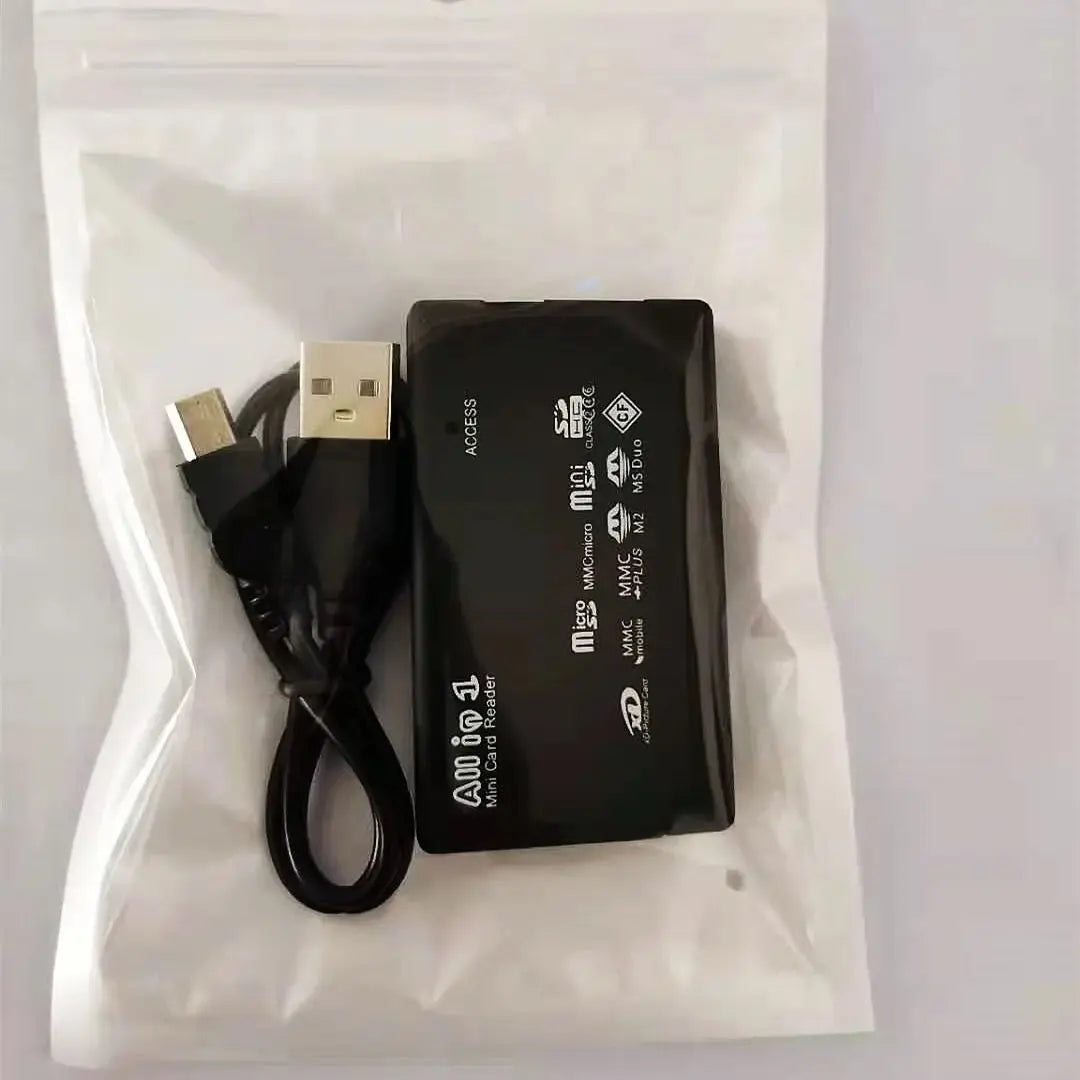 A USB 2.0 Mini Memory Card Reader With Multi-Card Support in black, including a USB cable, is packed in a transparent resealable plastic bag, with its ports and white printed labels clearly visible on the card readers surface.