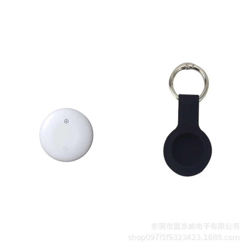 A round, white NoEnName GPS Tracker for pets is shown with a black keychain holder on a plain background. The tag has a circular marking, while the holder includes a metal keyring, easily connecting with your Find My App Locator for seamless tracking.
