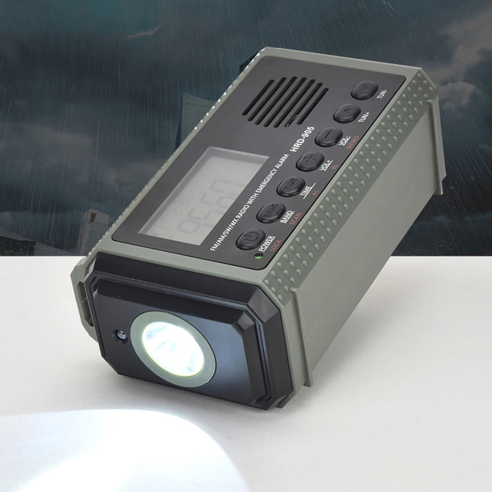 The APWIKOGER 10,000mAh Solar Hand Crank Emergency Radio rests on a surface, featuring a built-in flashlight, speaker, and control buttons. A stormy background highlights its crucial function in emergencies.