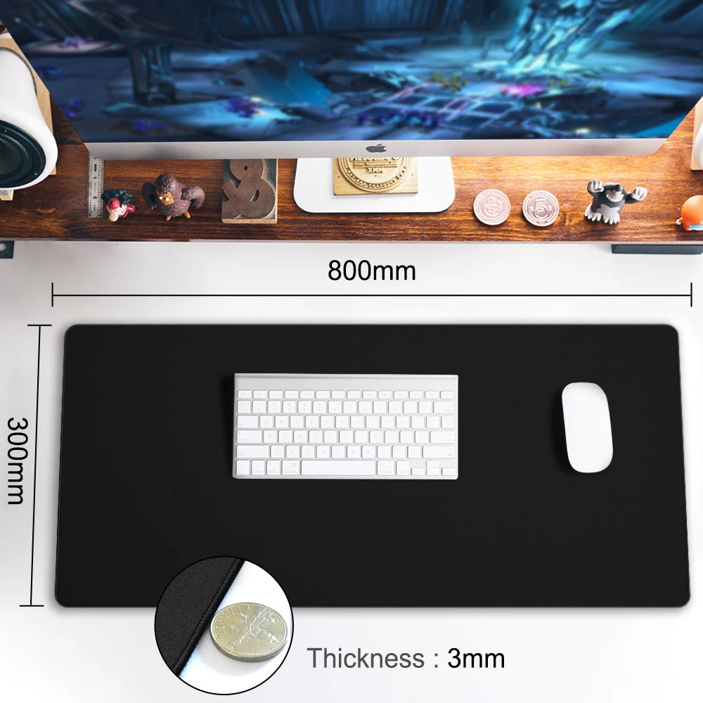 A desktop setup includes the Ziyoulang Large Mouse Pad 800x300mm with Stitched Edges, supporting a keyboard and mouse. A computer screen displays a game above, while decorative items and a drink complete the arrangement.
