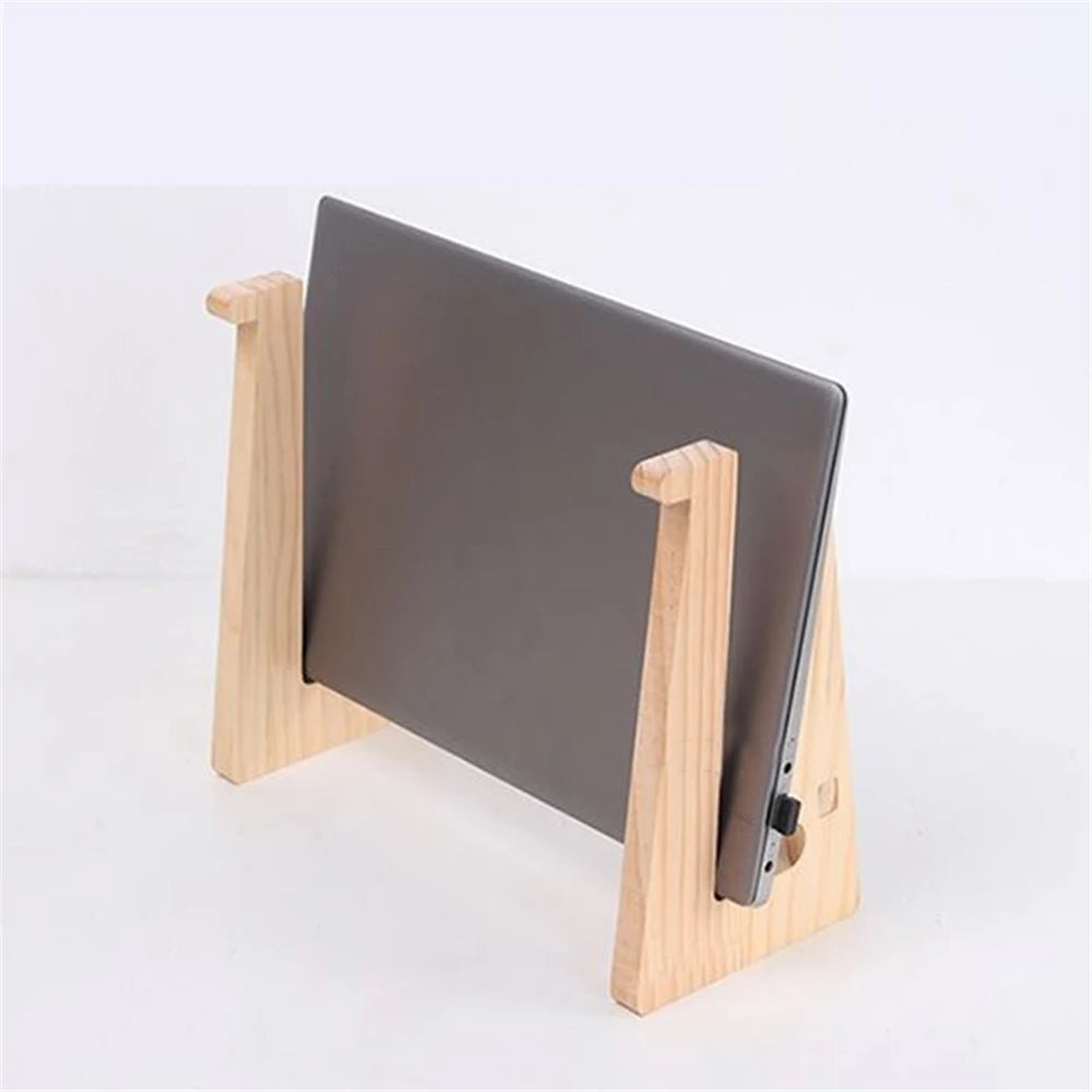 The Universal Wooden Laptop Holder - Detachable Stand holds a laptop vertically on a white surface with its minimalist design and two support sides. While the screen is hidden, the detachable feature adds practicality. Enjoy free shipping on every purchase.