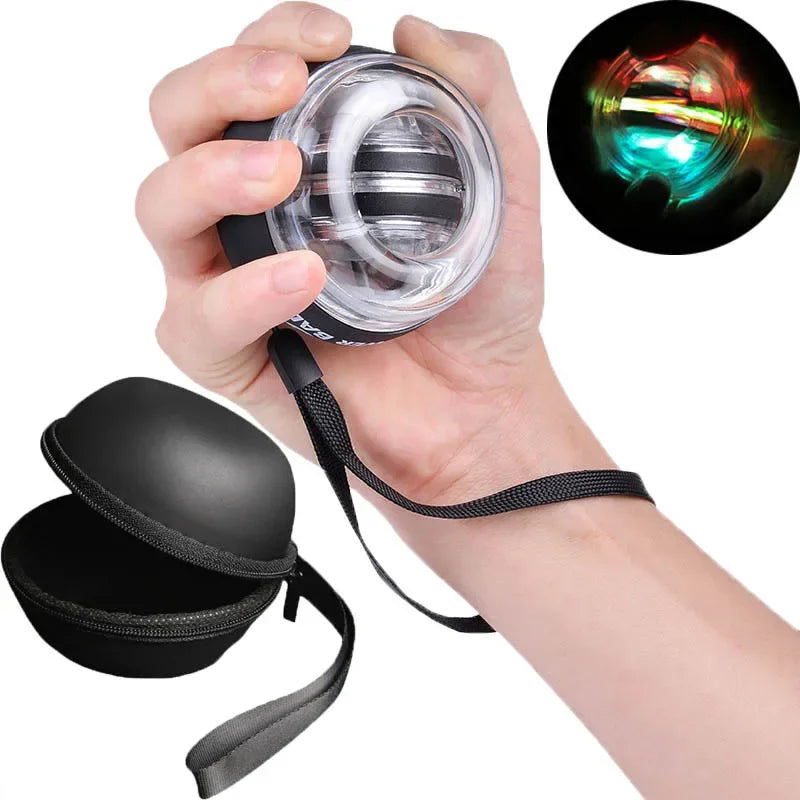 A hand grips the LED Gyro Wrist Force Handball with vibrant red and green lights. A sleek black carrying case with a strap is open nearby, perfect for enhancing your strength training routine.