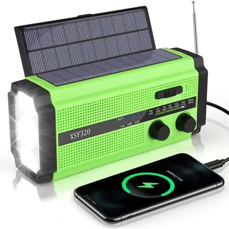 The Woopker 5000mAh Emergency Radio is green with solar panels, a hand crank LED flashlight, control knobs, and an extendable antenna. It connects to a smartphone via USB while charging it.