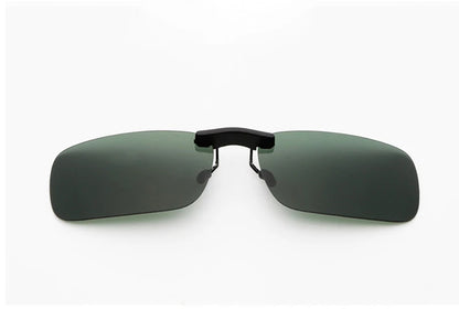 Honey Joe Polarized Clip-On Sunglasses offer UV400 protection and dark lenses, fitting over prescription glasses. Designed with a simple hinge and minimalist style, they ensure eye protection with elegance. The background is plain white.