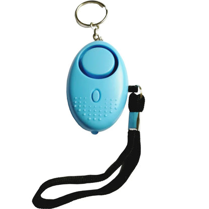 The 130dB Personal Safety Alarm Keychain, in small blue, includes a top keyring and side black wrist strap. Its textured grip under the circular button makes it essential for self-defense in any situation.