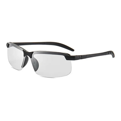 The HARKO Polarized Night Vision Cycling Sunglasses feature sleek, semi-rimless black frames and clear lenses perfect for outdoor adventures. With straight, slender arms that curve slightly, they rest against a plain white background.