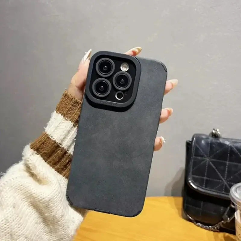 Luxury Matte Cortex Leather iPhone Case with shockproof protection, held in hand, showcasing sleek design and durability.