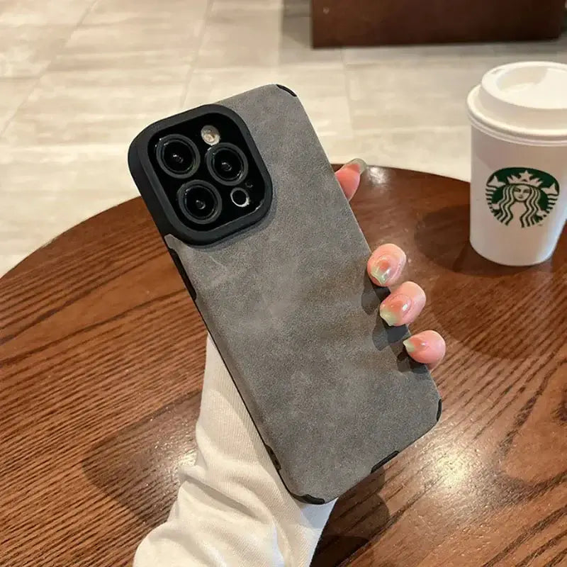 Luxury Matte Cortex Leather iPhone Case with Shockproof Protection held in hand on table