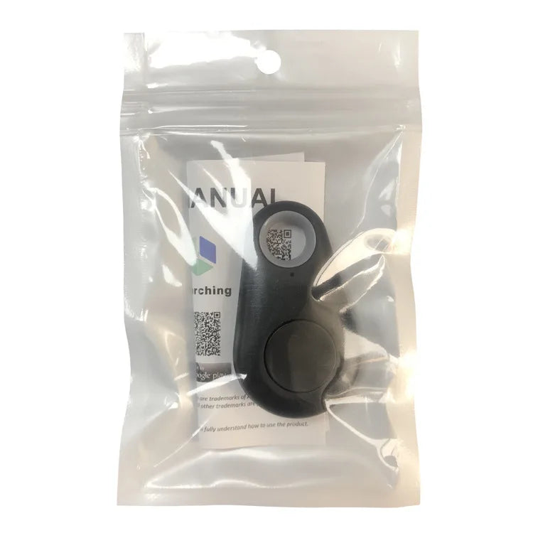 A Seamopar Mini GPS Tracker, compact and black with a loop and button, is in a clear resealable plastic bag. A partially visible manual with text and QR codes is behind it. The packaging highlights the keychains seamless anti-theft alerts and tracking functionality.
