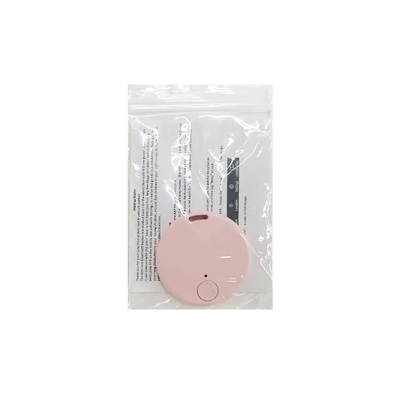 A small, round pink device with a button sits on a clear plastic pouch holding an instruction sheet—your Seamopar Mini GPS Tracker, the compact anti-lost Bluetooth key finder for efficient alerts.